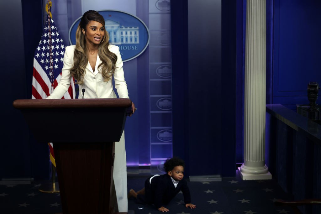 WASHINGTON, DC - NOVEMBER 17: Singer Ciara Princess Wilson (L) speaks to members of the press as her one-year-old son Win Harrison Wilson (R) crawls on the floor during a tour of the James Brady Press Briefing at the White House November 17, 2021 in Washington, DC. Ciara was at the White House to discuss with the first lady on promoting children ages 5 – 11 years old to get vaccinated against COVID-19. (Photo by Alex Wong/Getty Images)