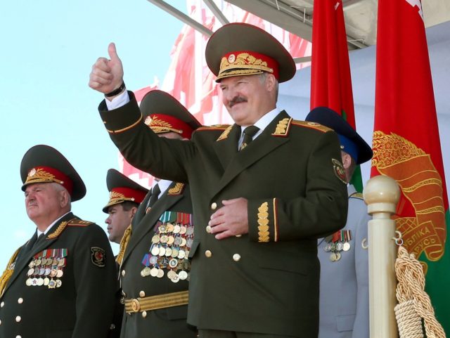 Belarus President Alexander Lukashenko (R) watches Independence Day parade in Minsk, on July 3, 2013. Belarus celebrated today Independence Day, an official holiday marking the day in 1944 when the Red Army liberated Minsk from Nazi troops during the World War II. AFP PHOTO / BELTA / POOL/ NIKOLAI PETROV …