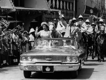 18th February 1966: The Queen and Prince Philip driving through Barbados waving to the cro