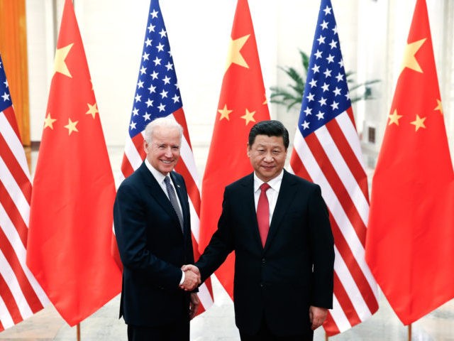 BEIJING, CHINA - DECEMBER 04: Chinese President Xi Jinping (R) shake hands with U.S Vice P