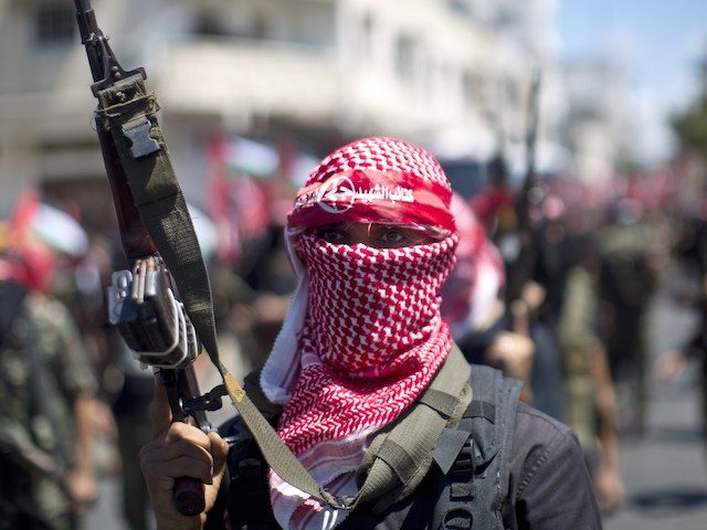 A masked Palestinian militant of the Popular Front for the Liberation of Palestine (PFLP), holds-up his rifle on September 2, 2014 in Gaza city during a rally to celebrate a week after the Egypt-mediated ceasefire between Israel and Hamas. Israel announced on September 1, 2014 it will expropriate 400 hectares …