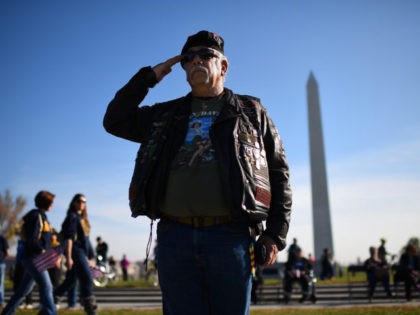 WASHINGTON, DC - NOVEMBER 11: Vietnam war veteran Joe 'Dragon' Lozano, retired U.S. Army, salutes during the playing of ÒTapsÓ at a Veterans Day ceremony at the World War Two Memorial November 11, 2014 in Washington, DC. Originally established as Armistice Day in 1919, the holiday was renamed Veterans Day …