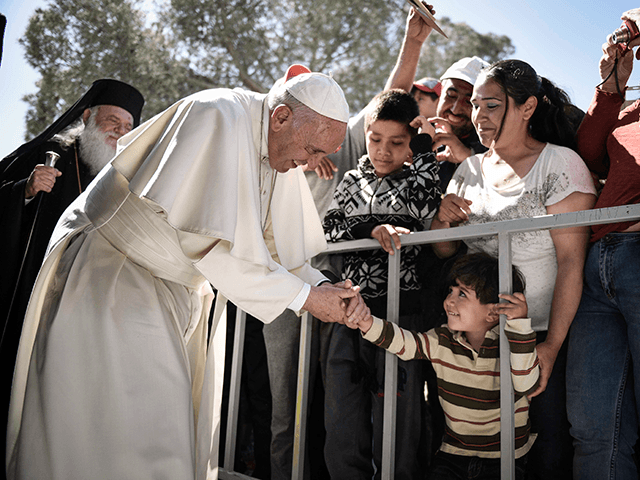 In this handout image provided by Greek Prime Minister's Office, Pope Francis meets migran