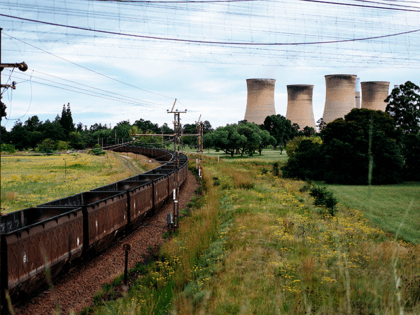A freight train leaves the Eskom Power plant in Hendrina on February 22, 2018, after having discharged its load of coal. - The name of Eskom, Africa's largest electricity company, has become synonymous with the worst corruption scandals in South Africa and the utility could well become the final nail …