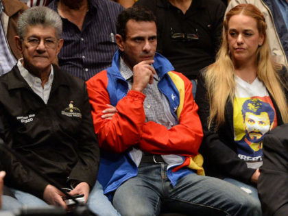 (L to R) Opposition deputy Henry Ramos Allup, opposition leader Henrique Capriles Radonski and Lilian Tintori, wife of Venezuela's currently under house arrest opposition leader, Leopoldo Lopez, attend a press conference to annonce the creation of a new opposition coalition, the "Frente Amplio Venezuela Libre" in Caracas on March 8, …