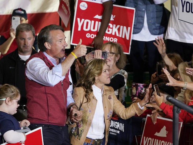 Republican gubernatorial candidate Glenn Youngkin, left, and his wife Suzanne, arrive for a rally in Chesterfield, Virginia, November 1, 2021. (AP Photo/Steve Helber)
