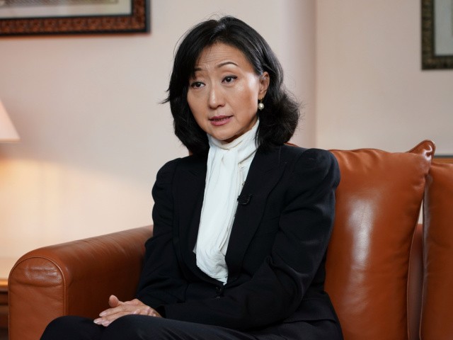 Grace Meng, the wife of former Interpol president Meng Hongwei, answers the Associated Press in Lyon, central France, Tuesday, Nov.16, 2021. In the exclusive interview, Meng chose to show her face for the first time since her husband disappeared in China in 2018, agreeing to be filmed and photographed without the dark lighting and from-the-back camera angles that she had previously insisted on. (AP Photo/Laurent Cipriani)