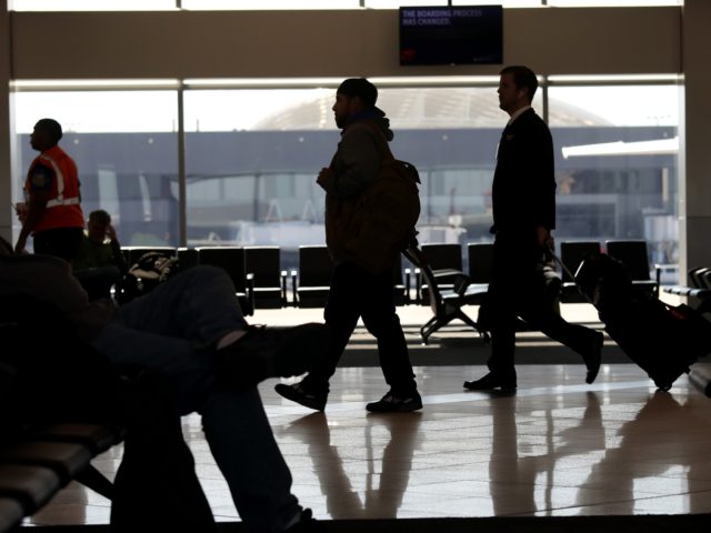 ATLANTA, GEORGIA - APRIL 20: Travelers walk through terminal A at Hartsfield-Jackson Atlan