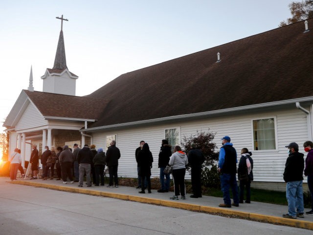 DES MOINES, IOWA - NOVEMBER 03: People stand in line to vote as the sun rises at Bloomfield United Methodist Church on November 3, 2020 in Des Moines, Iowa. After a record-breaking early voting turnout, Americans head to the polls on Election Day to cast their vote for incumbent U.S. …