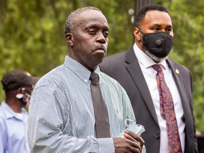 Ahmaud Arbery's father, Marcus Aubrey, center, walks away from the Glynn County Courthouse, Thursday, June 4, 2020, during a recess in the preliminary hearing of Travis McMichael, Gregory McMichael and William Bryan, in Brunswick, Ga. The three men are accused of shooting his son while he ran through their neighborhood …