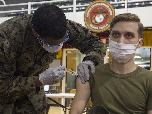 U.S. Marine Corps Sgt. Alen Ford, an airframes mechanic with Marine Light Attack Helicopter Squadron 269, 2nd Marine Aircraft Group, receives the coronavirus vaccine at Camp Lejeune, North Carolina, February 11, 2021. (U.S. Marine Corps photo by Sgt. Jesus Sepulveda Torres)