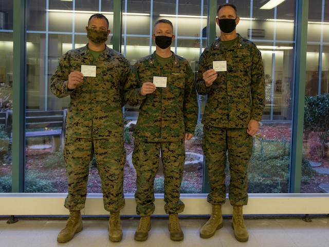 U.S. Marines Sgt. Maj. James Robertson, left, the sergeant major of Marine Corps Air Station (MCAS) Cherry Point, Col. Mikel Huber, center, the commanding officer of MCAS Cherry Point, and Lt. Col. Patrick Lindstrom, right, the executive officer of MCAS Cherry Point, pose after receiving the Moderna COVID-19 Vaccine at MCAS Cherry Point, North Carolina, on Dec. 23, 2020. The Department of Defense COVID-19 vaccination plan is phased. The vaccine received emergency use authorization from the Food and Drug Administration and election to accept the vaccination is voluntary. (U.S. Marine Corps photo by Lance Cpl. Jacob Bertram)