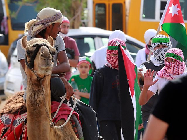 Supporters of Jordan's Muslim Brotherhood take part in a protest in the village of Sweimeh, near the Jordanian border with the occupied West Bank, on May 21, 2021, to express their solidarity with Palestinians and to celebrate the ceasefire. (Khalil Mazraawi/AFP via Getty Images)