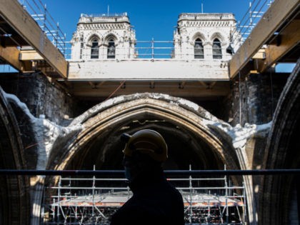 A worker stands on scaffolding under the vault of the Notre-Dame de Paris Cathedral ahead of a visit of French President two years after the blaze that made the spire collapsed and destroyed much of the roof, in Paris on April 15, 2021. - The actual restoration work has yet …