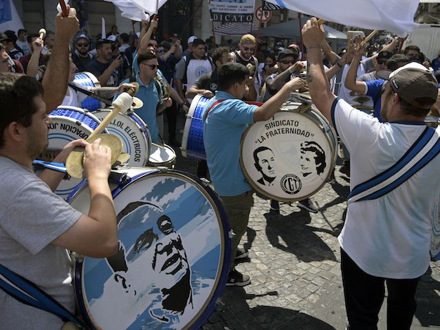 People play drums with portraits of late former leader Juan Domingo Peron and his wife Eva Duarte, also konwn as "Evita", during a march in Buenos Aires on October 18, 2021, during a rally to celebrate the Day of the Loyalty to Peronism. (Juan Mabromata/AFP via Getty Images)