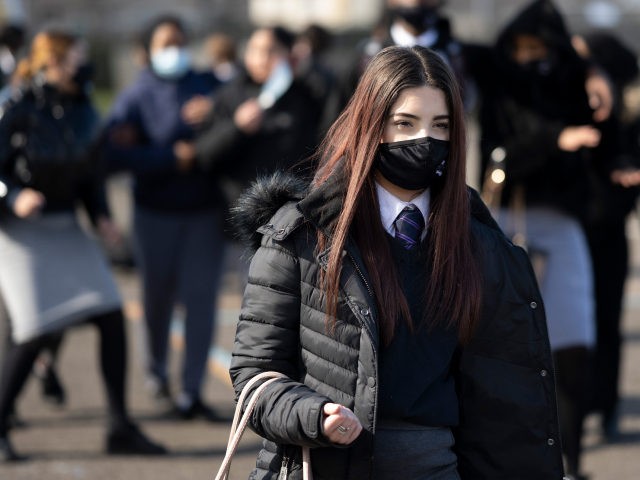 CARDIFF, WALES - MARCH 16: A schoolgirl wearing a face mask leaves a lesson at Willows High School on March 16, 2021 in Cardiff, Wales. Secondary schools in Wales reopen this week having been closed to most pupils since the beginning of the year due to Covid-19 concerns. (Photo by …