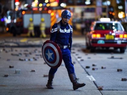 A man wearing a Captain America costume walks on a street as protesters and pedestrians gather near the Mong Kok police station in Hong Kong on October 7, 2019. (Mohd Rasfan/AFP via Getty Images)