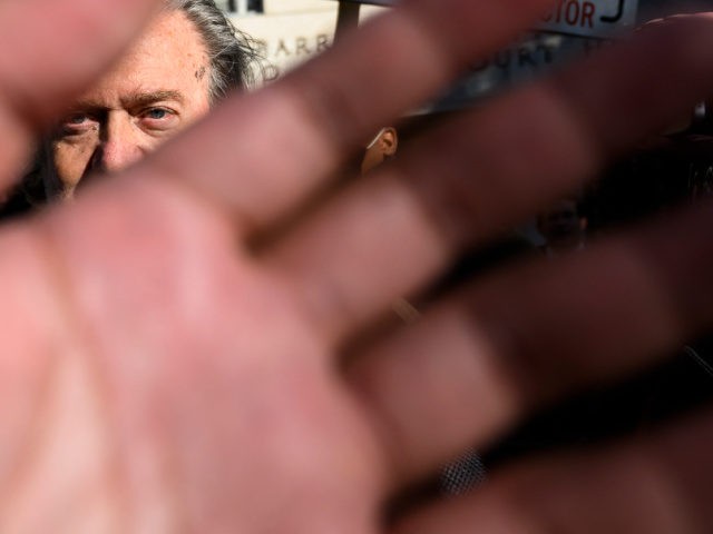 Former Trump Administration White House advisor Steve Bannon is seen through security blocking the media after an appearance in the Federal District Court in Washington, DC on November 15, 2021. - A defiant Steve Bannon, former president Donald Trump's long-time advisor, turned himself into the FBI Monday to face charges …