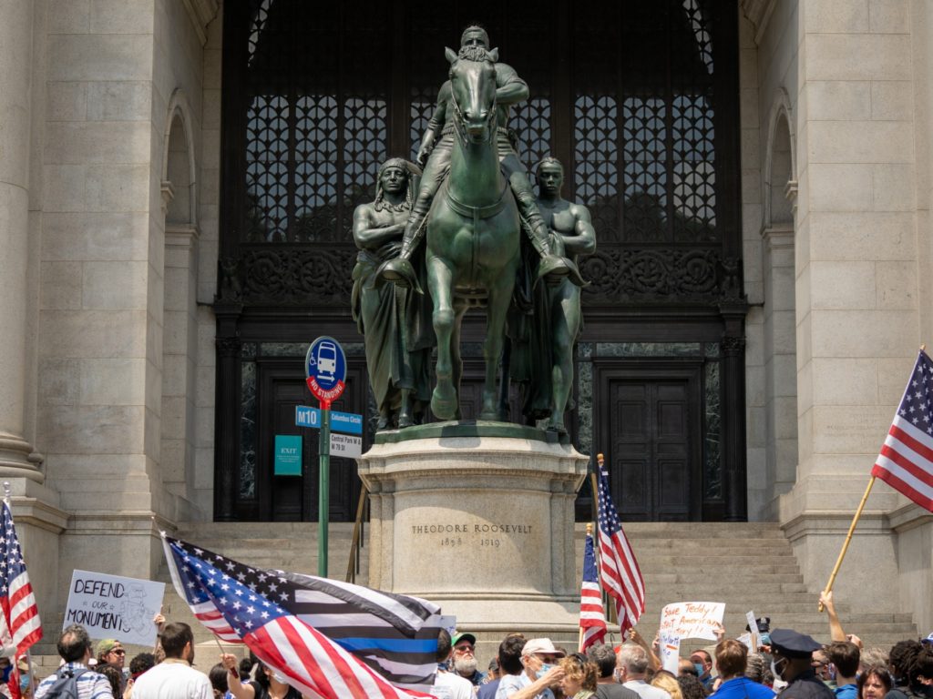 NEW YORK, NY - JUNE 28: A rally lead by the New York Young Republican Club calls for the Equestrian Statue of Theodore Roosevelt to remain in place on June 28, 2020 in New York City. The American Museum of Natural History has requested that the City of New York and Mayor Bill de Blasio remove the statue as part of a movement to remove racist monuments across the country. In a statement, the museum added that the statue itself communicates a racial hierarchy that the Museum and members of the public have long found disturbing. (Photo by David Dee Delgado/Getty Images)