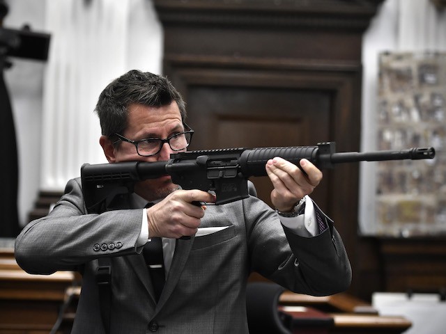 Assistant District Attorney Thomas Binger holds Kyle Rittenhouse's gun as he gives the state's closing argument in Kyle Rittenhouse's trial at the Kenosha County Courthouse on November 15, 2021 in Kenosha, Wisconsin. (Sean Krajacic-Pool/Getty Images)