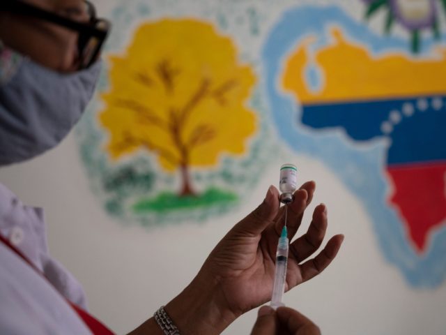 A Venezuelan doctor prepares a syringe with a dose of the COVID-19 vaccine developed by Ch