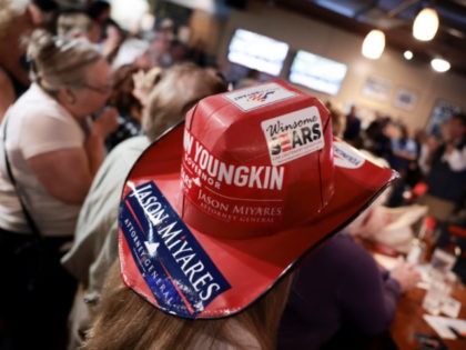 NORFOLK, VIRGINIA - OCTOBER 25: Political stickers are seen on a woman's cowboy hat at a campaign event for Virginia Republican gubernatorial candidate Glenn Youngkin at the Azalea Inn & Time Out Sports Bar on October 25, 2021 in Norfolk, Virginia. Youngkin is facing Democratic candidate and former Virginia Gov. …