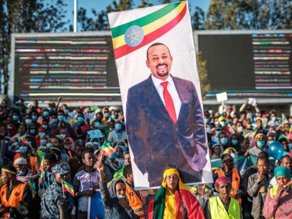 TOPSHOT - A woman holds a banner with the portrait of Primer Minister Abiy Ahmed during a