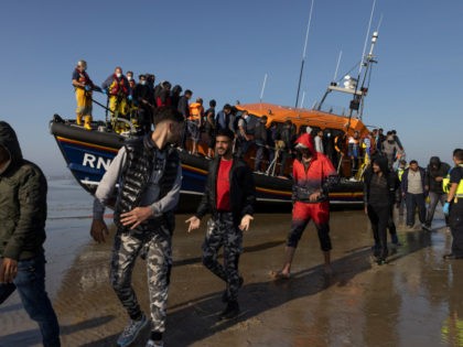 DUNGENESS, ENGLAND - SEPTEMBER 07: A group of migrants arrive via the RNLI (Royal National Lifeboat Institution) on Dungeness beach on September 7, 2021 in Dungeness, England. The week has seen a major increase in migrant numbers due to fair weather. (Photo by Dan Kitwood/Getty Images)