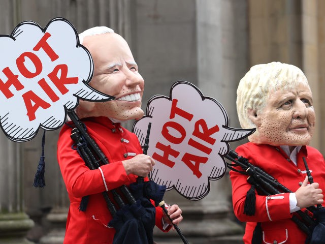 GLASGOW, SCOTLAND - NOVEMBER 01: Protestors dressed as US President Joe Biden and British Prime Minister Boris Johnson at a Oxfam demonstration outside the Gallery Of Modern Art on November 01, 2021 in Glasgow, Scotland. As World Leaders meet to discuss climate change at the COP26 Summit, many climate action …