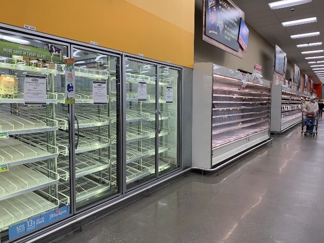 Shoppers are seen wandering next to near empty shelves in a supermarket in Houston, Texas following winter storm Uri that left millions without power and caused water pipes to burst, on February 20, 2021. - Texas authorities have restored power statewide bringing relief after days of unprecedentedly frigid temperatures, but …