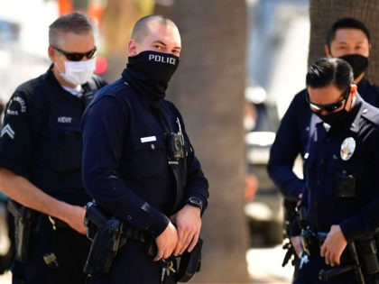 Los Angeles Police Department (LAPD) officers wear facial covering while monitoring an "Op