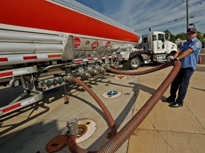 A fuel truck driver for Exxon works air out of the hose as he fills the underground tanks at a Exxon gas station June 25, 2009, in Centreville, Virginia. AFP Photo/Paul J. Richards (Photo credit should read PAUL J. RICHARDS/AFP via Getty Images)