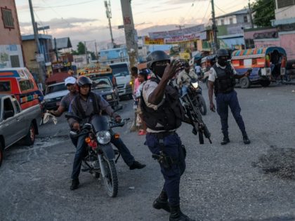 Police officers patrol at an intersection in Port-au-Prince, Haiti, Thursday, Nov. 11, 2021.The U.S. government is urging U.S. citizens to leave Haiti given the country's deepening insecurity and a severe lack of fuel that has affected hospitals, schools and banks. (AP Photo/Matias Delacroix)