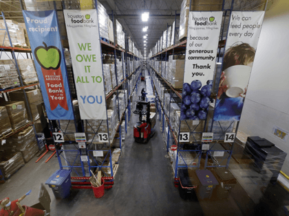 Pallets of various foods are stacked on shelves in the extensive warehouse at the Houston Food Bank Wednesday, Oct. 14, 2020, in Houston. It's the largest U.S. food bank and national food bank leaders say they don't see an end in sight to the demand. (AP Photo/Michael Wyke)