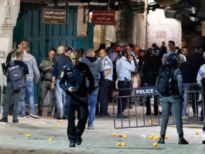 Members of the Israeli security forces gather at the scene in the old city of Jerusalem where a knife attack reportedly took place, on November 17, 2021, wounding two police officers police said. - The assailant armed with a knife stabbed two officers near a Jewish religious school in the …