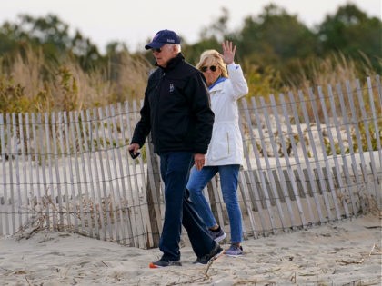 President Joe Biden and first lady Jill Biden walk along the beach in Rehoboth Beach, Del.