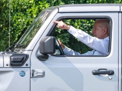 US President Joe Biden drives a Jeep Wrangler Rubicon 4xe after delivering remarks on the steps his Administration is taking to strengthen American leadership on clean cars and trucks on the South Lawn of the White House in Washington, DC, on August 5, 2021. (Photo by JIM WATSON / AFP) …