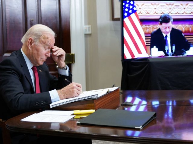 US President Joe Biden gestures as he meets with China's President Xi Jinping during a vir