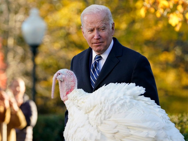 President Joe Biden walks past Peanut Butter, the national Thanksgiving turkey, after he w