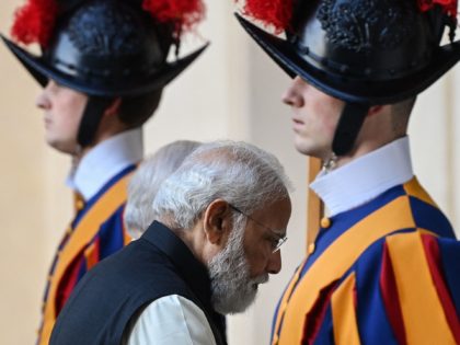 Indian Prime Minister Narendra Modi walks past Swiss Guards as he arrives on October 30, 2021 at San Damaso courtyard in The Vatican for a private audience with the Pope. (Photo by Vincenzo PINTO / AFP) (Photo by VINCENZO PINTO/AFP via Getty Images)