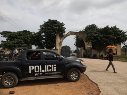 A police truck is stationed outside the University of Abuja Staff Quarters gate where unkn
