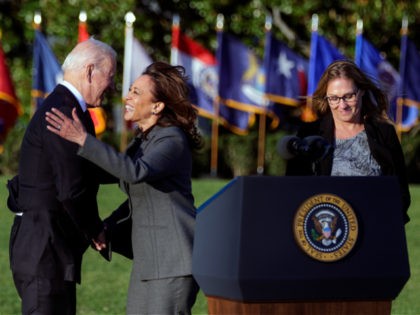 WASHINGTON, DC - NOVEMBER 15: U.S. Vice President Kamala Harris hugs President Joe Biden while steelworker Heather Kurtenbach (R) watches, as Biden prepares to deliver remarks during the signing ceremony for the Infrastructure Investment and Jobs Act on the South Lawn at the White House on November 15, 2021 in …