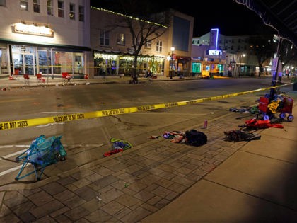 Police tape cordons off a street in Waukesha, Wis., after an SUV plowed into a Christmas parade hitting multiple people Sunday, Nov. 21, 2021. (AP Photo/Jeffrey Phelps)