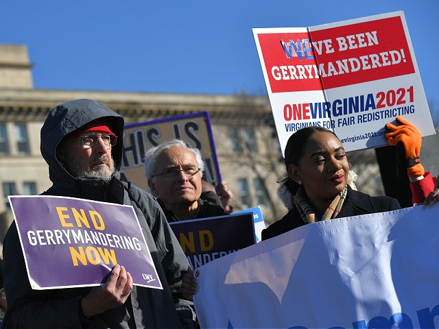 People gather during a rally to coincide with the Supreme Court hearings on the redistricting cases in Maryland and North Carolina, in front of the US Supreme Court in Washington, DC on March 26, 2019. - The US Supreme Court is set Tuesday to once more hear arguments on gerrymandering, the dark art of redrawing political boundaries to extract partisan advantage: a practice that is almost as old as the country itself. The latest cases to come before the highest bench are from North Carolina, where Republican lawmakers are accused of devising electoral maps to favor themselves; and Maryland, where Democrats are accused of the same. (Photo by MANDEL NGAN / AFP) (Photo credit should read MANDEL NGAN/AFP via Getty Images)