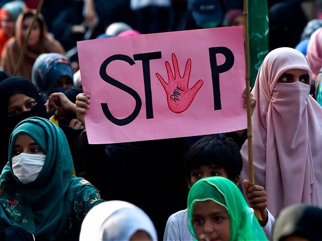 A supporter of Pakistani Islamic political party Jamaat-e-Islami (JI) holds a placard read