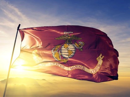 United States Marine Corps flag textile cloth fabric waving on the top sunrise mist fog - stock photo