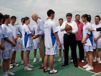 Vice President Joe Biden and Chinese Vice President Xi Jinping greet basketball at Qingchengshan High School in Dujiangyan, China, Aug. 21, 2011. The high school was severly damaged in the 2008 Wenchuan earthquake and has since been rebuilt. (Official White House Photo by David Lienemann)