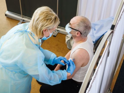 A medical worker vaccines a man against the coronavirus (Covid-19) in Ventspils, Latvia, on March 30, 2021, on the first day of a practice run for mass vaccination against the coronavirus (Covid-19) launched by the Northern Kurzeme Regional Hospital, as the government tries to ramp up vaccinations nationwide. - Latvia …