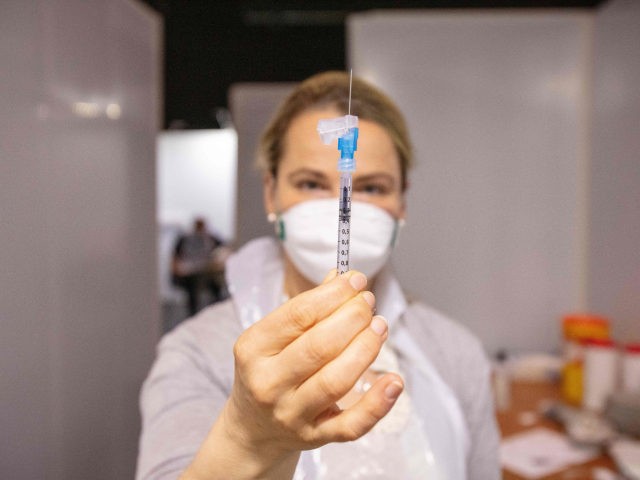 A healthcare professional prepares a dose of the Pfizer/BioNTech Covid-19 vaccine at a vac