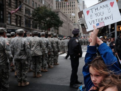 NEW YORK, NY - NOVEMBER 11: Gavin Kinney (9) holds up a sign thanking veterans at the nation's largest Veterans Day Parade in New York City on November 11, 2015 in New York City. Known as "America's Parade" it features over 20,000 participants, including veterans of numerous eras, military units, …
